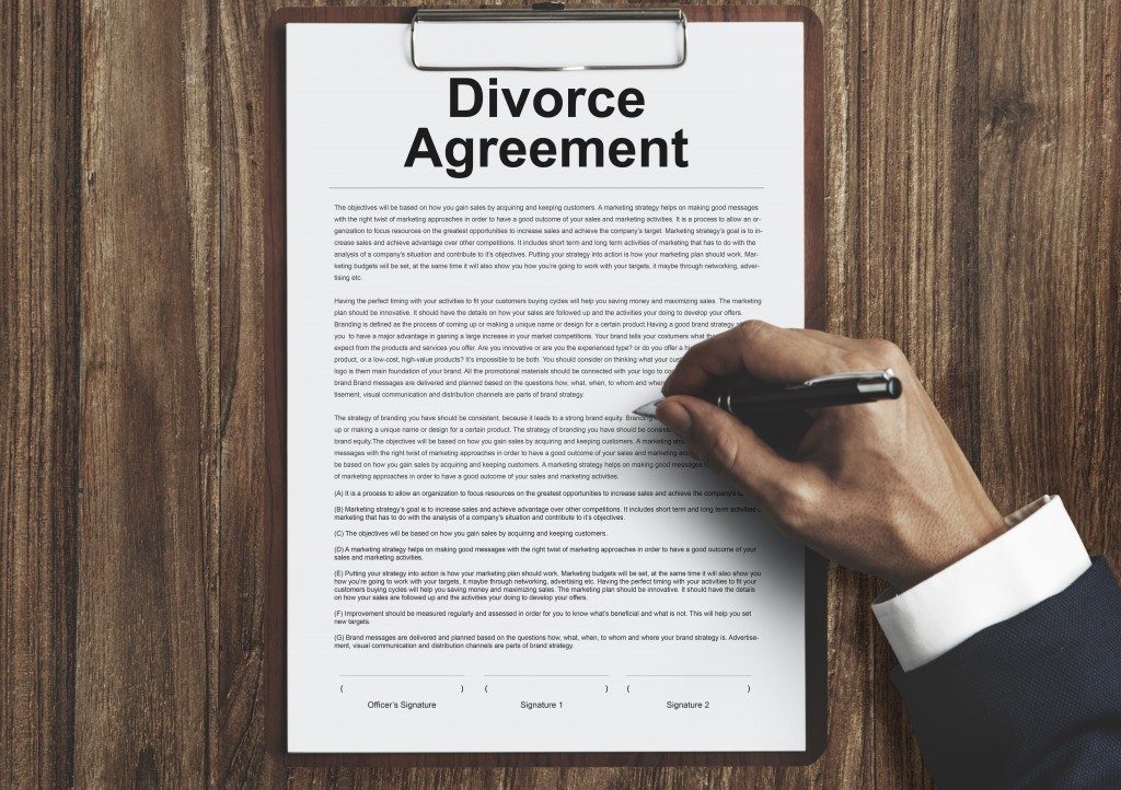 Divorce agreement paperwork being signed