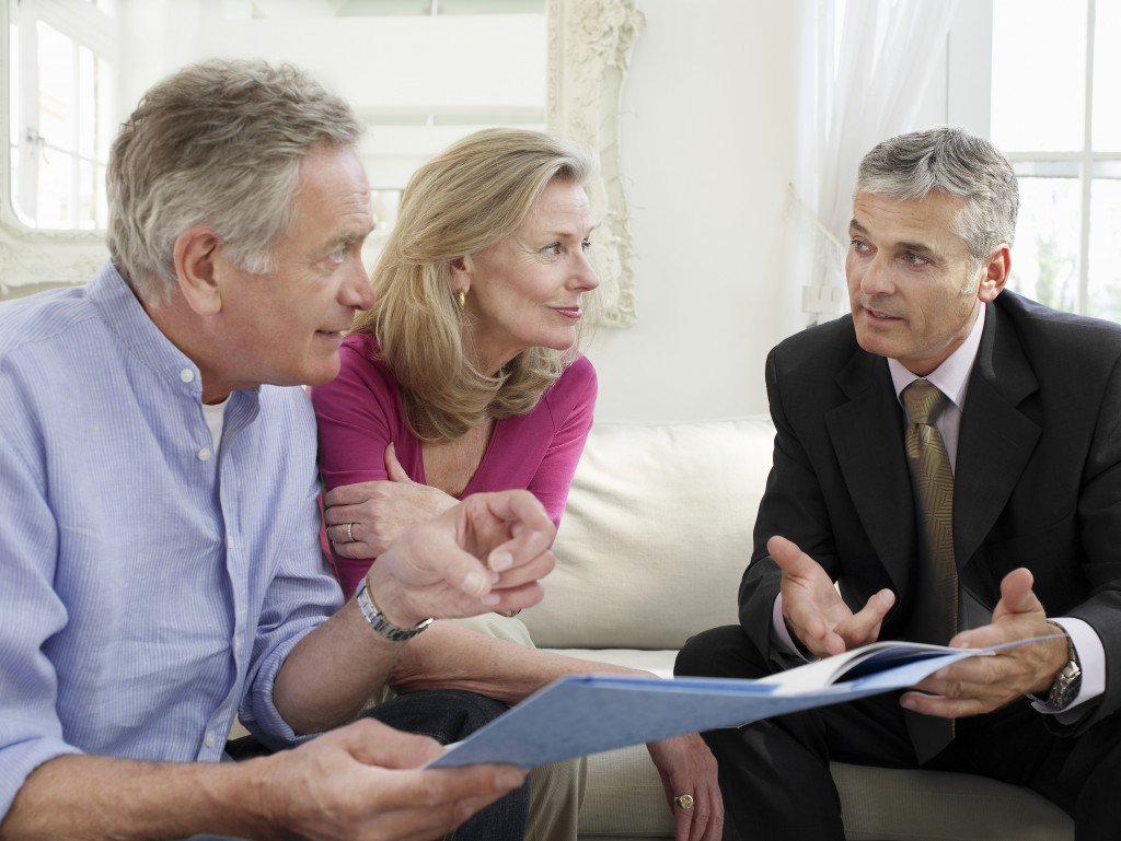 seniors on a sofa with financial advisor